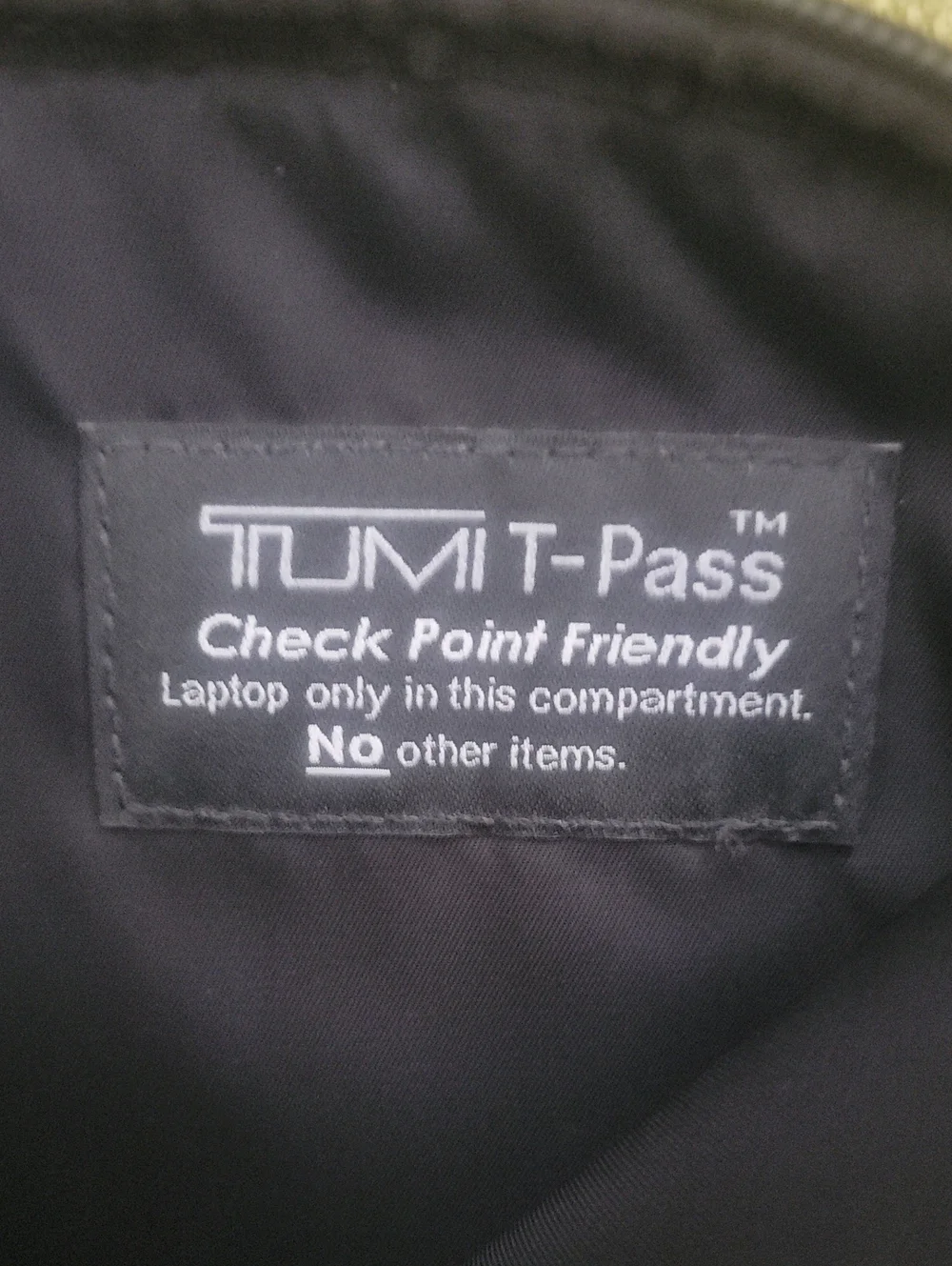 Tumi Black Sleeve with Beige Logo Patch